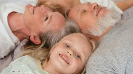 Family lying on bed
